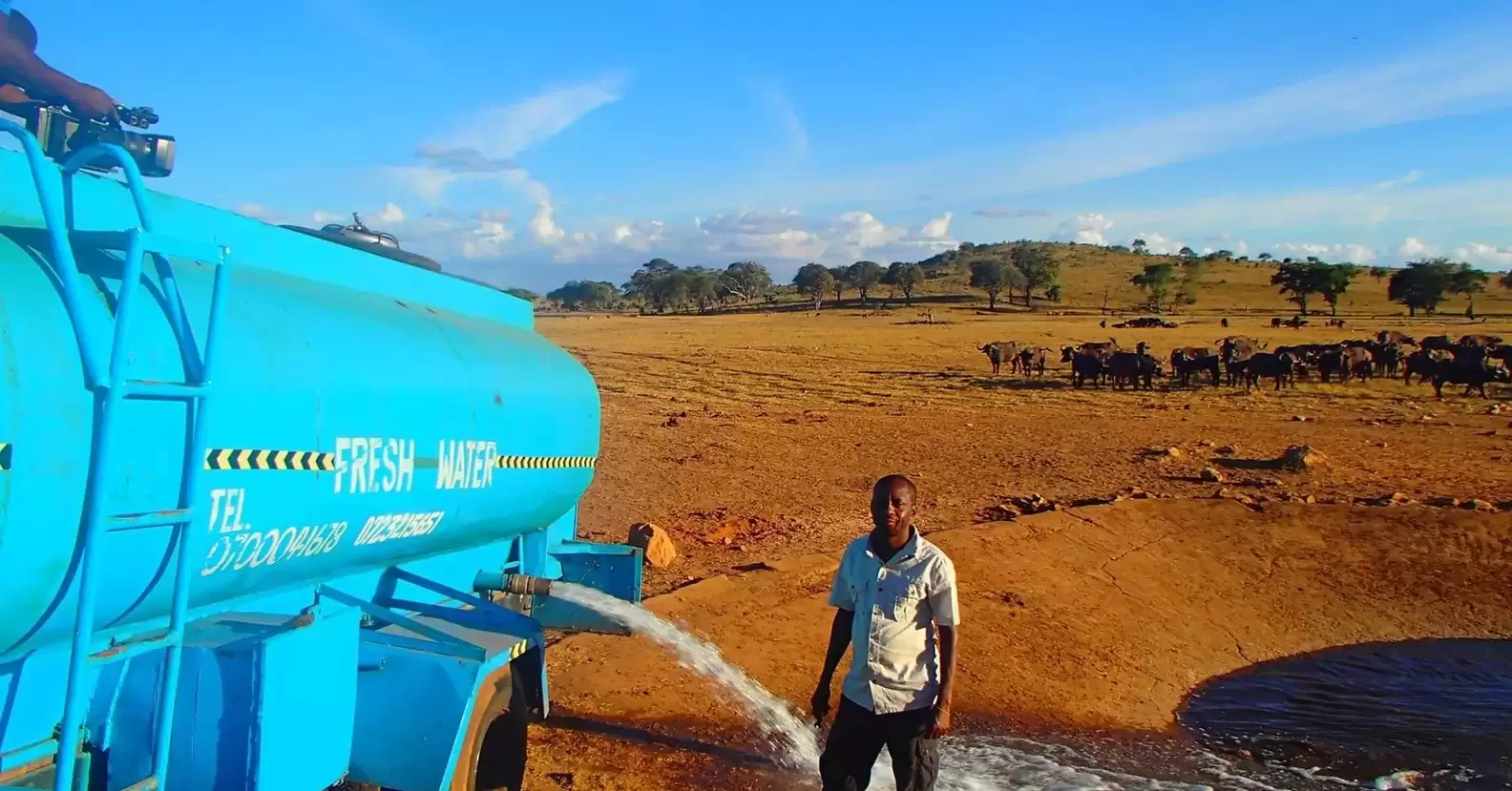 A man travels for hours daily through a drought to provide water for wild animals 1