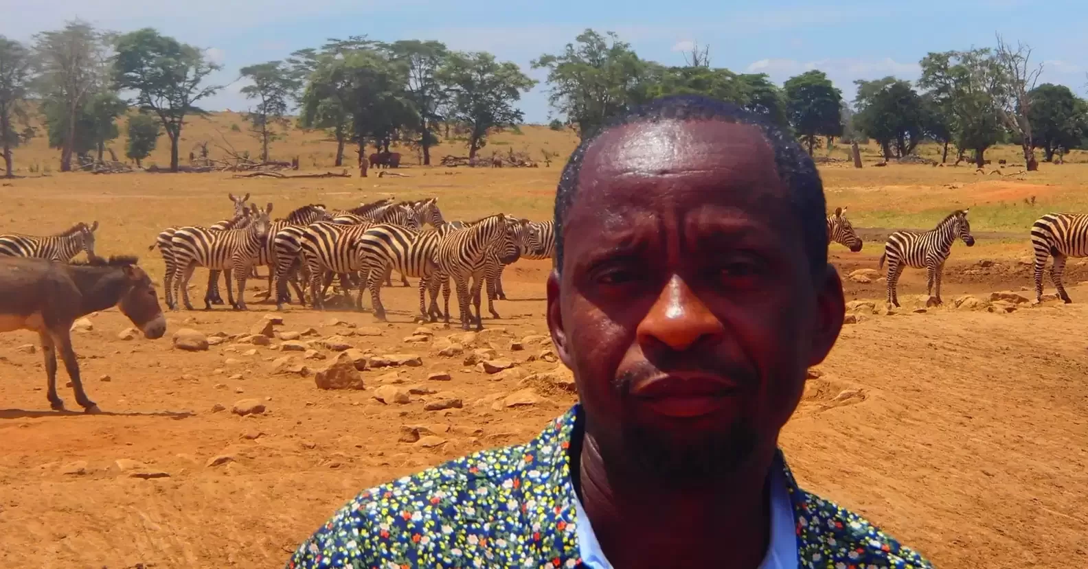 A man travels for hours daily through a drought to provide water for wild animals 10