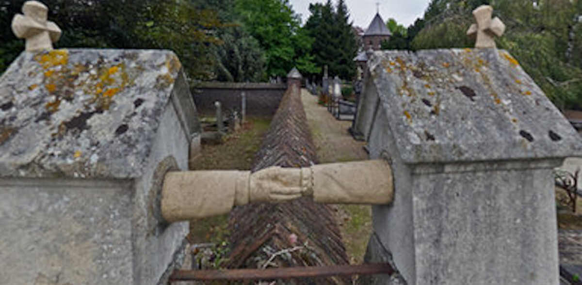 Graves holding hands over wall a Catholic woman and her Protestant husband 2